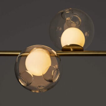 Exceptional Bocci 28 Stem suspension lamp with clear glass spheres and unlacquered brass supporting a milk white interior holder