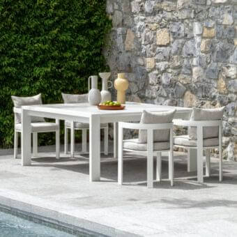 Distinguished Talenti Argo Alu table with a square form and clean lines in white powder-coated aluminum creating a striking outdoor centerpiece