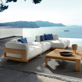 Distinguished Talenti Argo Wood sectional with accoya wood frame, white cushions and contrasting blue accents, a natural finish