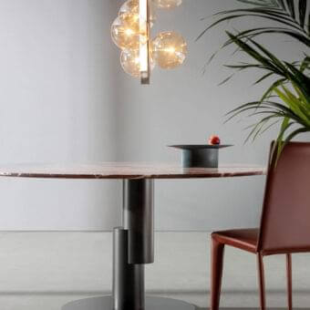 Distinctive Bonaldo Innesti table with a composite marbled tabletop in brown, pink and cream shades and dark matte cylindrical metal base