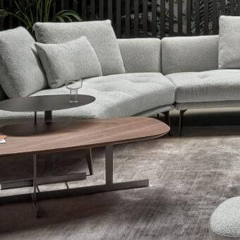 Distinguished Bonaldo Kumo side table with bold geometric metal base and curved top in matte dark finish