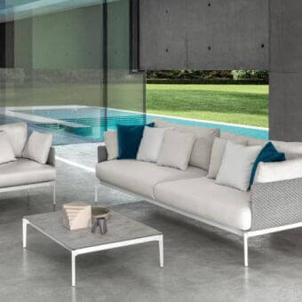 Distinguished Talenti Leaf lounge chair with light aluminum structure and dark blue cushion in light gray matte textile