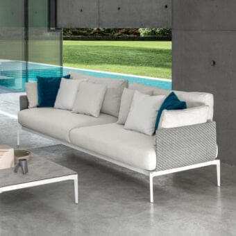 Elegant Talenti Leaf sofa with woven synthetic fiber side panels and plush light beige cushions accented in teal