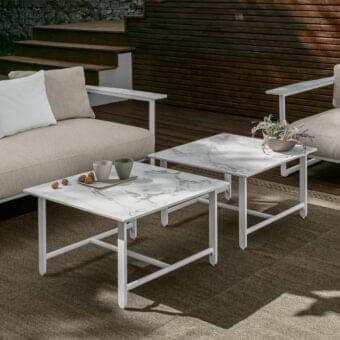 Elegant Talenti Riviera coffee table with a square stoneware top and matte white aluminum base exhibiting gray veining
