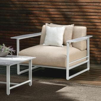 Exclusive Talenti Riviera lounge chair with light aluminum structure and light beige cushions enriched by bold textured fabrics with stoneware armrests