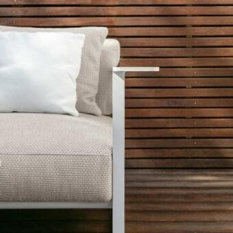 Superior Talenti Riviera lounge chair with light beige textile cushions and stylish stoneware armrests crafted in white aluminum