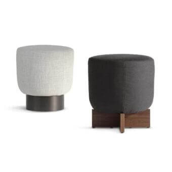 Distinguished Bonaldo Belt & Cross ottoman with gently curved padded top and dark metal base in a subtle matte textile