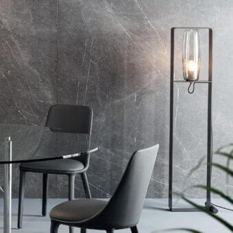 Architectural Bonaldo Bio-S floor lamp with a matte black metal structure and transparent blown glass lampshade
