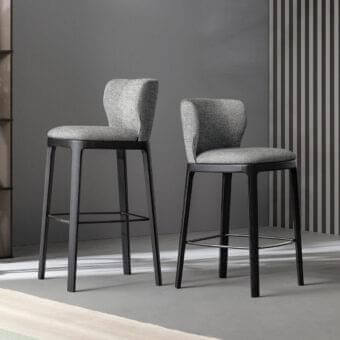 Distinguished Bonaldo Joy stool with solid wood base and light gray fabric seat, enhanced by a metal lead finish footrest