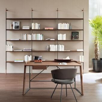 Elegant Bonaldo Roll bookcase with lead-finished metal tubes supporting dark brown wood shelves in a minimalist design