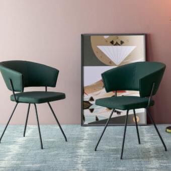 Exceptional Bonaldo Bahia armchair with dark green upholstery and slender black metal legs offering a contemporary design
