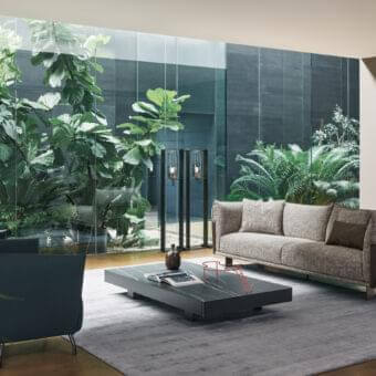 Elegant Bonaldo Blend sofa with light gray textured fabric and dark brown emery leather detailing in sleek matt painted metal