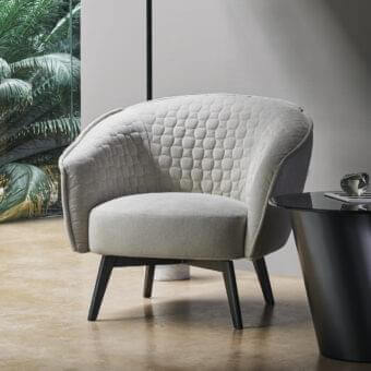 Sophisticated Bonaldo Bruno lounge chair with textured light beige upholstery and satin dark-toned wooden legs