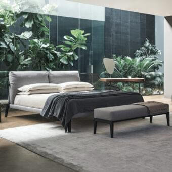 Superior Bonaldo Kriss bed with upholstered headboard and dark slender legs in light gray textile construction