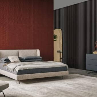 Elegant Bonaldo River bed with light beige textured upholstery and slender metal legs creates a welcoming centerpiece
