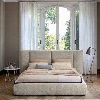 Distinguished Bonaldo Youniverse bed with large padded headboard delicately folded inward in neutral beige textile upholstery