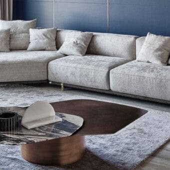 Distinguished Rugiano Boheme sectional with light gray woven fabric, metal base and leather details, exhibiting a polished finish