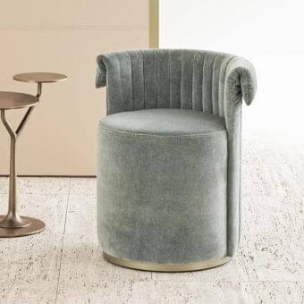 Exceptional Rugiano Manta ottoman with smooth grey textile upholstery and vertical stitching on a bronze plinth base