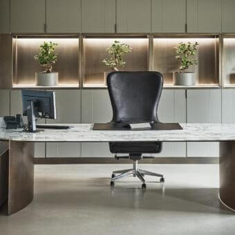 Superior Rugiano President desk with curved bronze legs supporting a marble-patterned tabletop in white and gray hues