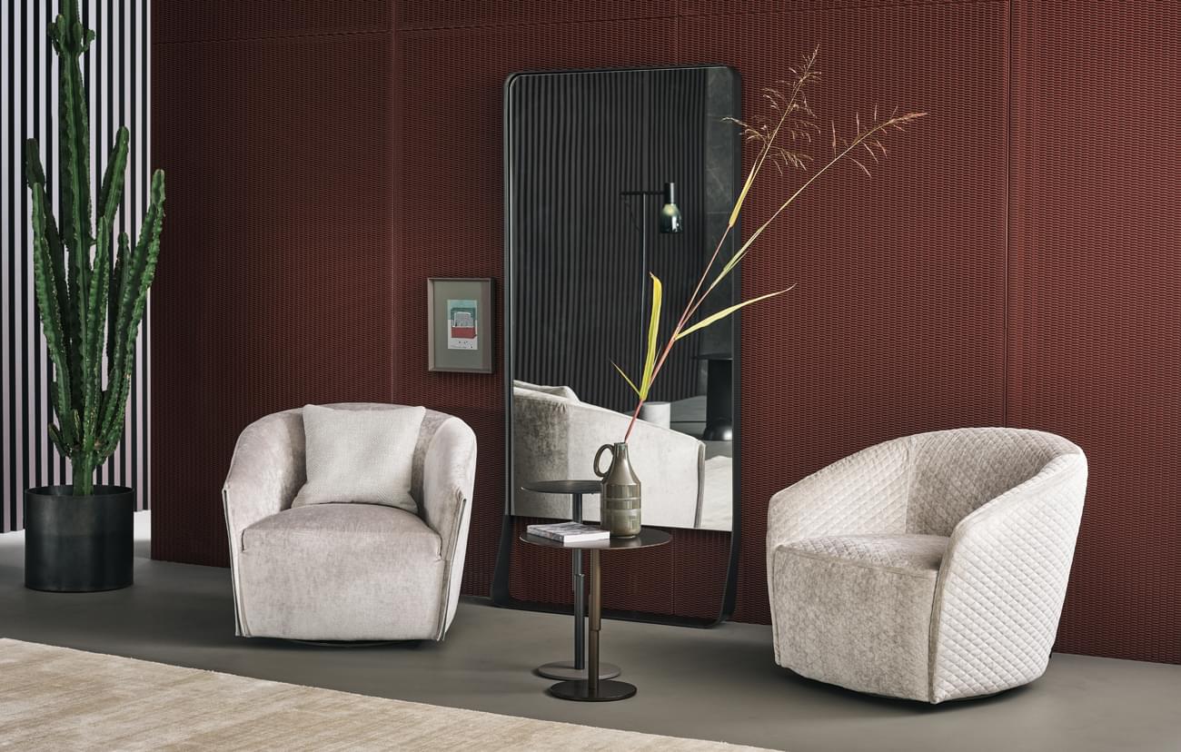 Superior Bonaldo Bodo lounge chair in soft light beige quilted fabric with a refined leather armrest insert