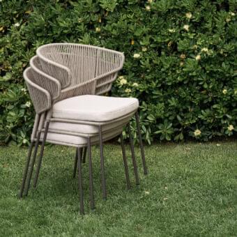 Elegant Potocco Ola armchair with a curved silhouette hand-woven in Fly ribbon and a neutral textile seat with matte metal legs