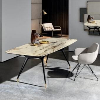 Elegant Sovet Italia Arkos table with beige and brown artificial marble top and sleek black X-shaped legs with gold-toned feet