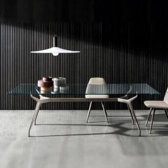 Distinctive Sovet Italia Arkos table with refined glass top and light gray-beige die-cast aluminum X legs
