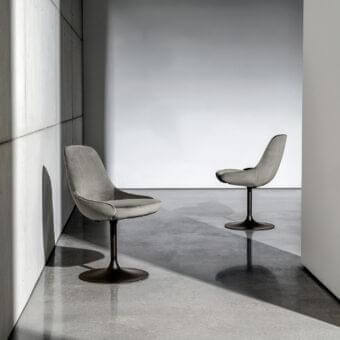 Superior Sovet Italia Cadira chair upholstered in muted gray textile with embossed black lacquered metal base