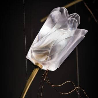 Distinguished Slamp Tulip suspension lamp with a translucent blossom and brushed brass stem accented by woven copper wires