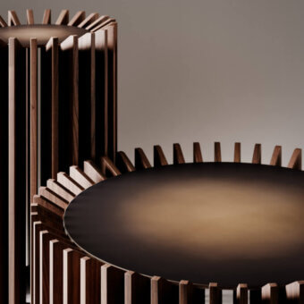 Innovative VENICEM Blade coffee table with black metal structure and refined matt canaletto walnut blades in burnished brass finish