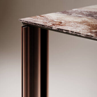 Serge table, marble-look surface, dark metal base; rectangular tabletop with swirling brown and beige tones, ribbed cylindrical legs.