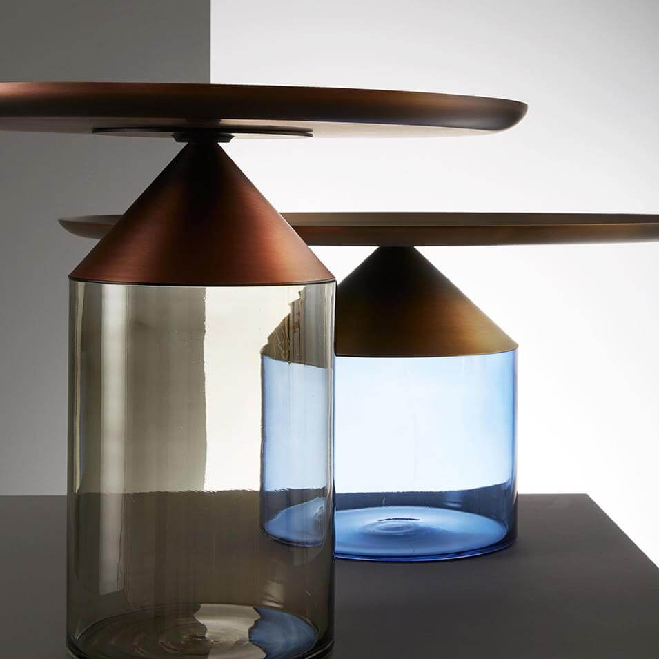 Table lamps, glass and metal, cylindrical smoky gray and blue bases with conical copper shades and circular shelf details.