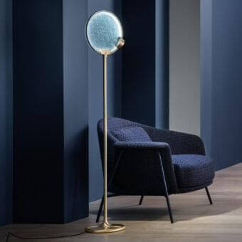 Elegant Masiero Horo floor lamp with metal structure and light blue glass diffuser exhibiting a glossy golden finish