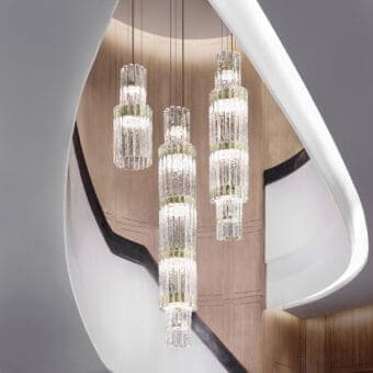 Distinguished Masiero Vegas VRT suspension lamp with a metal structure and rock-effect glass strips in a clear cylindrical form with gold-toned bands