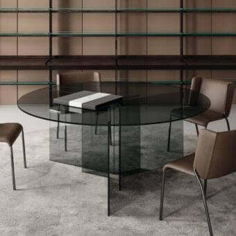 Distinguished Tonelli Design Thrim table with angled glass panels supporting a transparent smoky-tinted glass top