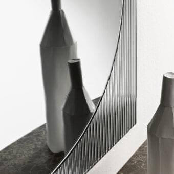 Distinguished Tonelli Design Bands mirror with reeded glass creating depth and texture in a glossy metal frame