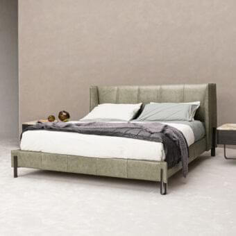 Distinguished Arketipo Big Night bed with muted green synthetic leather upholstery and matte finish featuring angular metal clasps