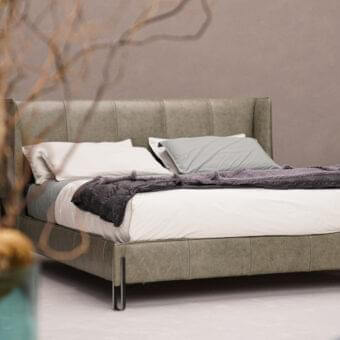 Distinguished Arketipo Big Night bed with angular metal clasp and muted gray-green textile upholstery with a matte finish