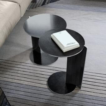 Superior Arketipo Joystick side table with curved metal leg connecting two circular plates in dark tones