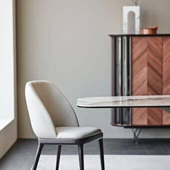 Refined Cattelan Italia Mariel chair in soft leather with a dark matte wooden base and tailored backrest stitching