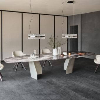 Captivating Cattelan Italia Senator table with irregularly shaped glass and asymmetrical metal bases in dark gray with veined accents and beveled edges