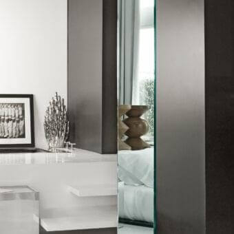 Exceptional Tonelli Design Soglia mirror with revolving glass base and subtly green-tinted glass edges