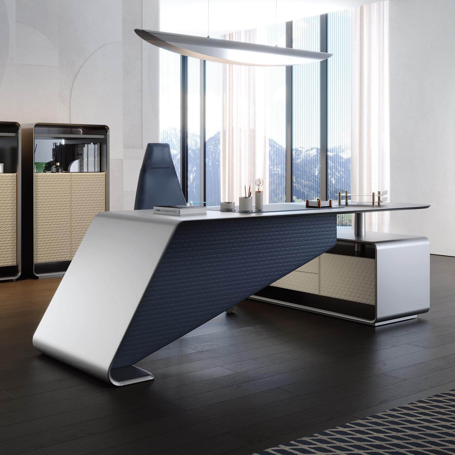 Executive desk with dark gray textured surface, light gray sculpted base, paired with black leather Cassoni chair in modern office setting.