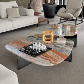 Captivating Arketipo Rumors coffee table with curvaceous marble surface and intersecting metal blades in orange, gray, and white tones