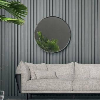 Elegant Bonaldo Adone mirror with a round silhouette and slim dark metal rim, exhibiting a subtle matte finish