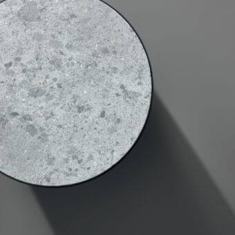 Distinguished Bonaldo Pisa coffee table with recessed terrazzo-like top in shades of gray and blue, exhibiting a smooth matte finish