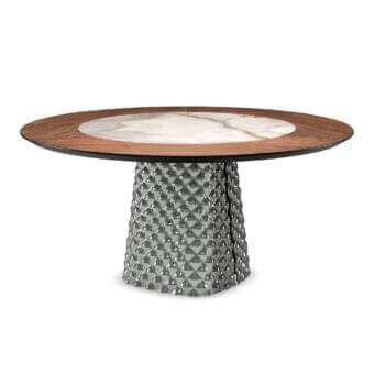 Dark and light circular disc rests on a gray textured column composed of small pyramidal shapes