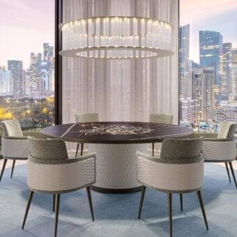 Refined Reflex Big Ben table with cylinder base upholstered in geometrically-patterned quilted leather and dark stone-like tabletop with gold inlay