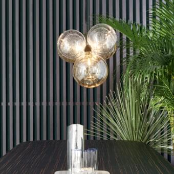Sophisticated Bonaldo Bon Ton suspension lamp with eleven glass lampshades in amber and transparent tones supported by slender metal cables