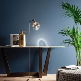 Elegant Bonaldo Sofi floor lamp with amber borosilicate glass globe and burnished brass cylinder